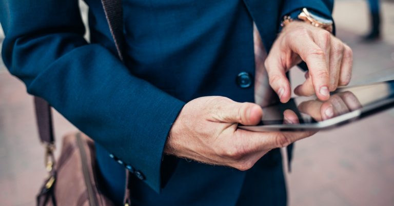 Businessman Using a Tablet on the Street